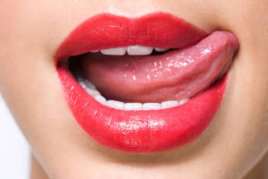 Woman licking lips, close-up